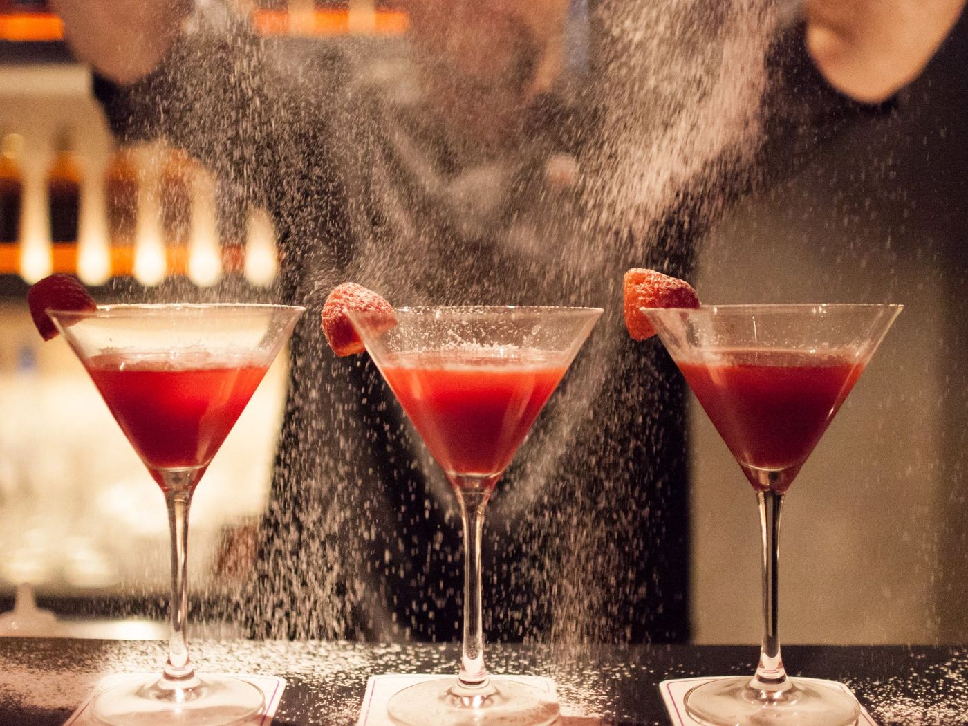 Three red martinis dusted with sugar